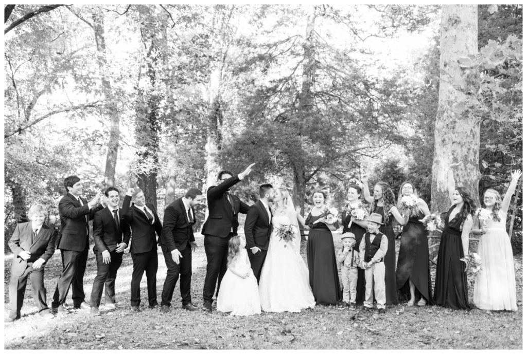 rustic vintage inspired wedding Charlottesville B & B fall Wedding  bride groom kissing and wedding party photo outdoors with flower girl and ring bearer
