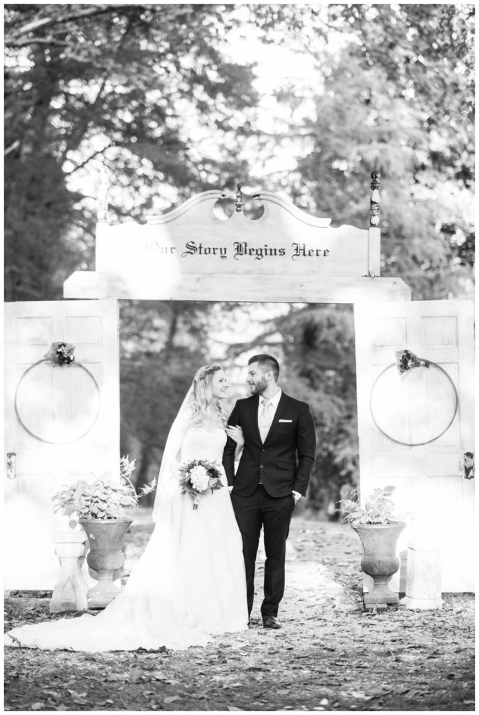 rustic vintage inspired wedding Charlottesville B & B fall Wedding bride groom outdoors with door and floral hoop backdrop