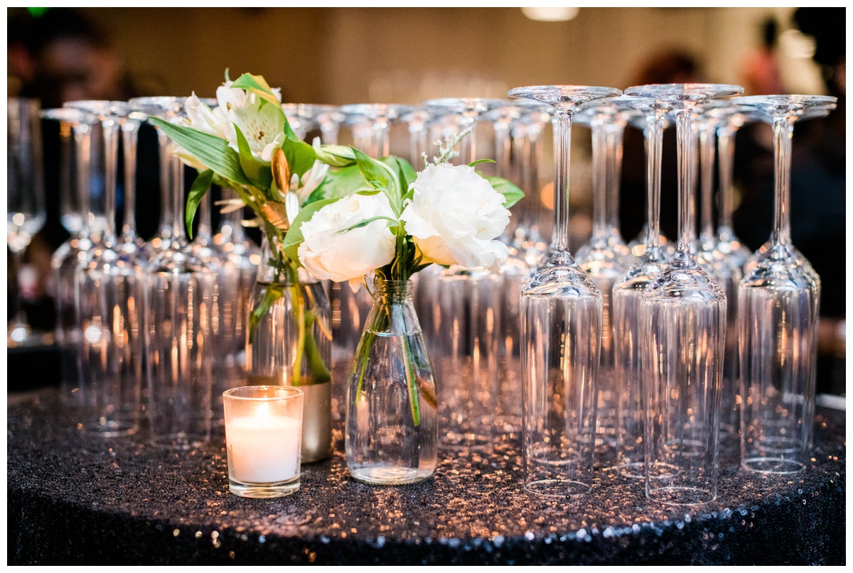 classic new years eve wedding richmond virginia table scape flower centerpieces with candles inspiration rva wedding venue redskins training center events rva wedding photographer black and gold new years eve place setting inspiration wedding flower decoration rva catering inspiration champagne glasses display