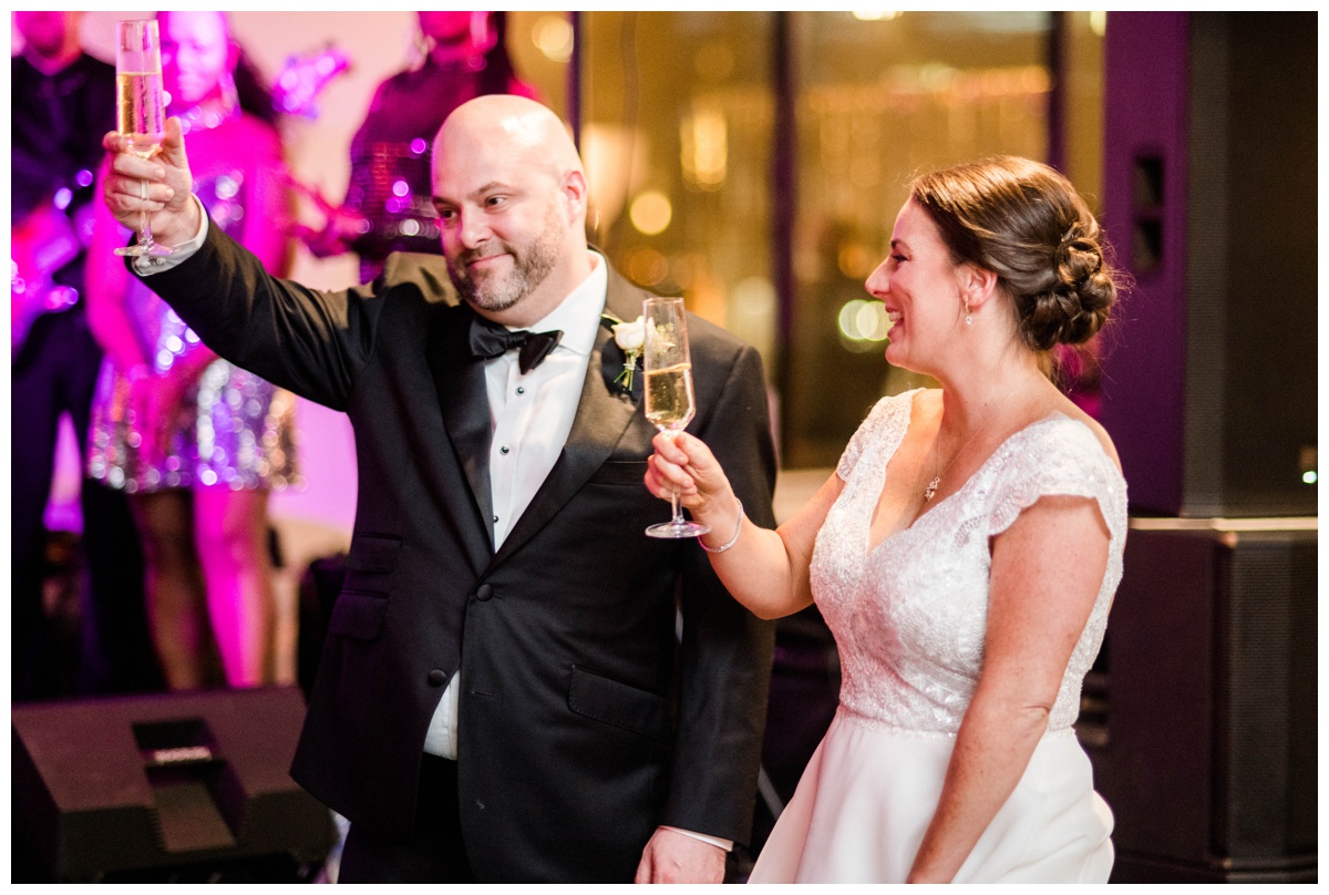 Classic new year's eve wedding black and gold wedding colors richmond virginia wedding venue redskins training center events rva richmond bride and groom wedding photographer raise the glass toast to the bride and groom happy couple