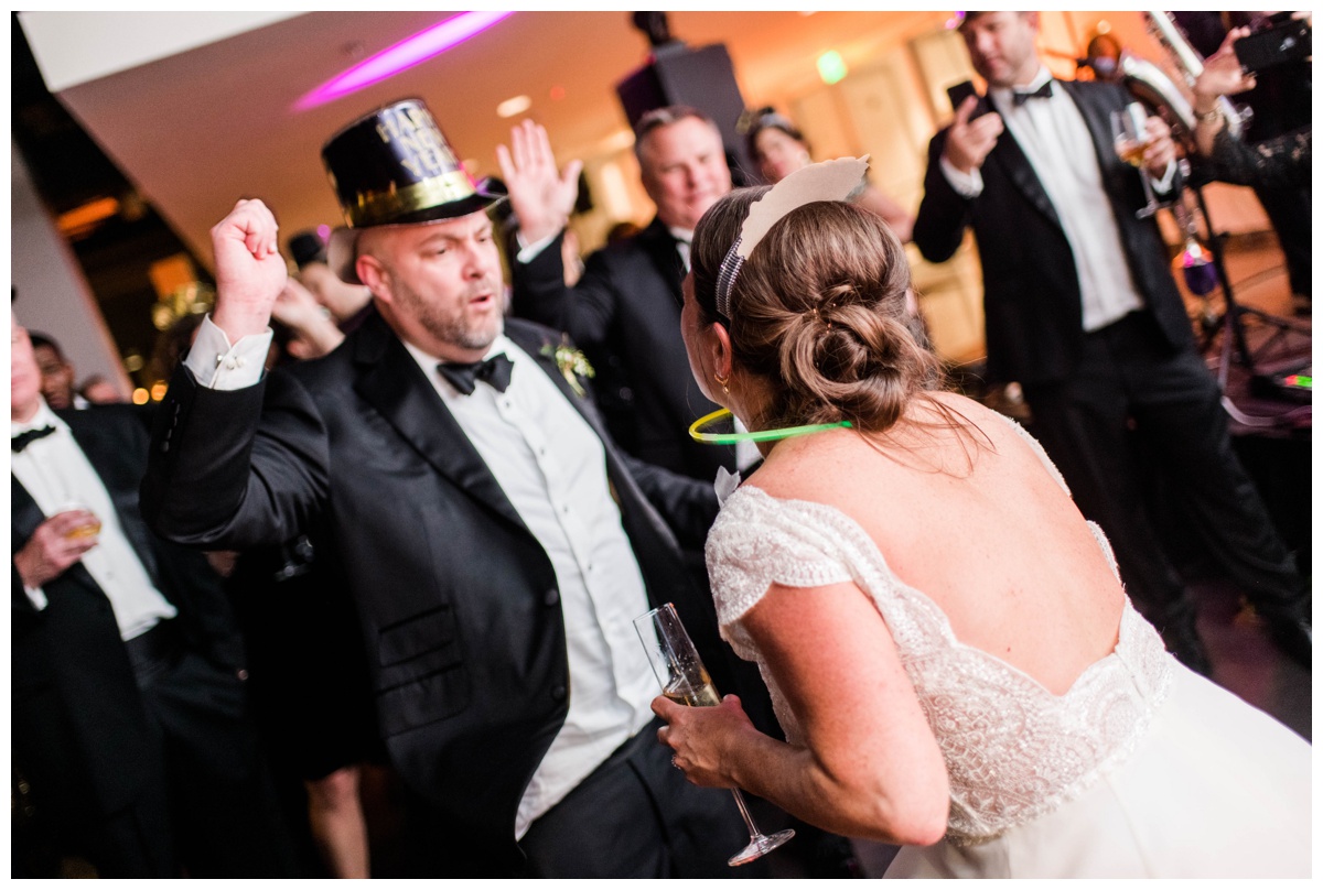 new years eve inspired wedding richmond wedding venue bon secours redskins training events center rva ball drop bride and groom dancing mr and mrs wedding photographer glow necklace