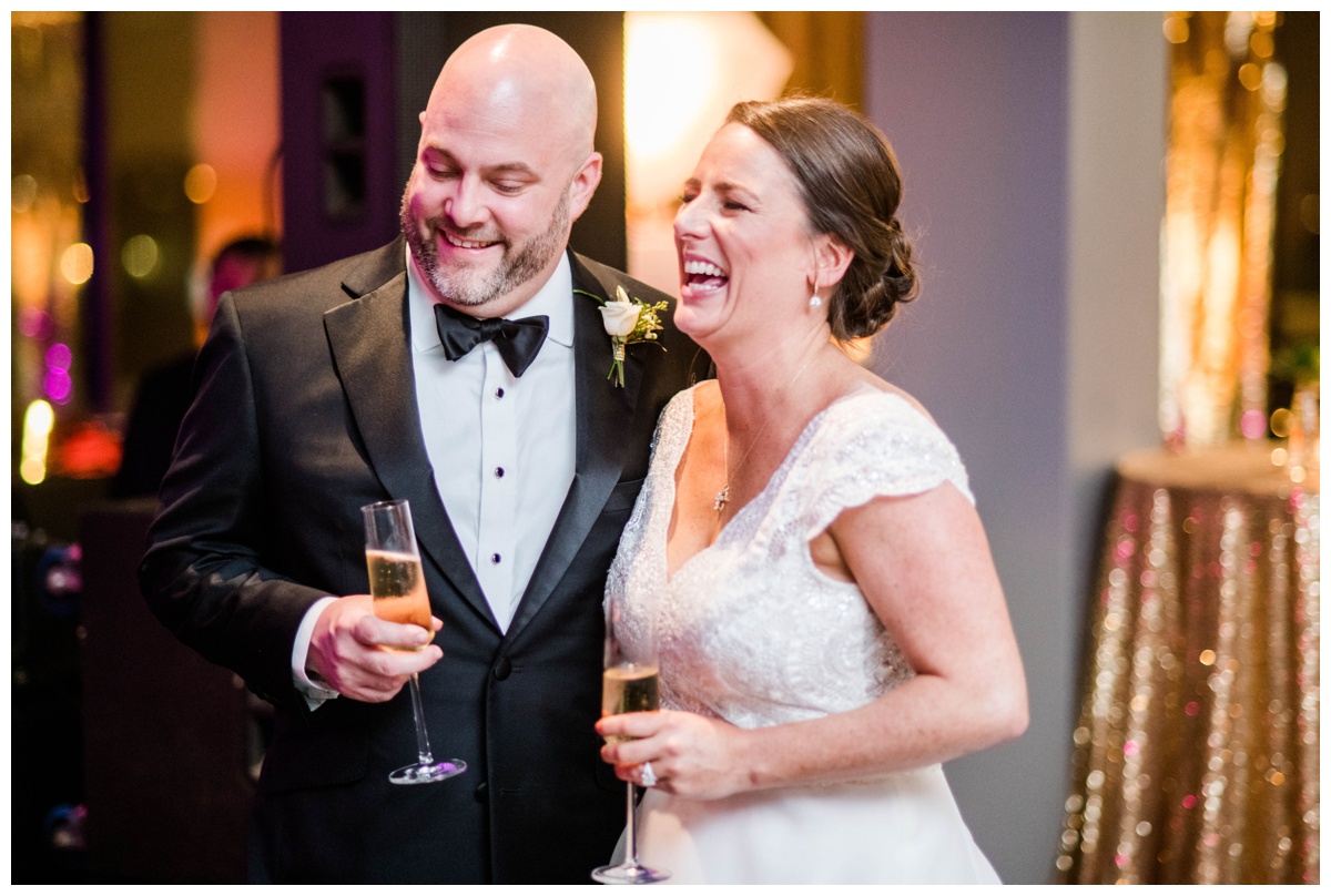 Classic new year's eve wedding black and gold wedding colors richmond virginia wedding venue redskins training center events rva richmond bride and groom wedding photographer raise the glass toast to the bride and groom laughing
