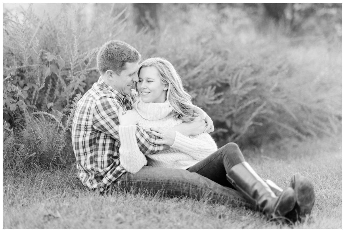 fall engagement photos in the grass nature couple smiling at quiet waters park in annapolis maryland by md wedding photographers sarah & dave photography