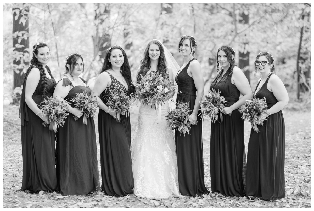 Whimsical Woodland Fall Wedding at mountain memories at thorpewood in thurmont maryland in october by sarah & dave photography richmond wedding photographer deep dark purple bridesmaid dresses holding bouquet wedding party photos with bride formal portrait ideas bridal party formal portrait inspiration black and white photo