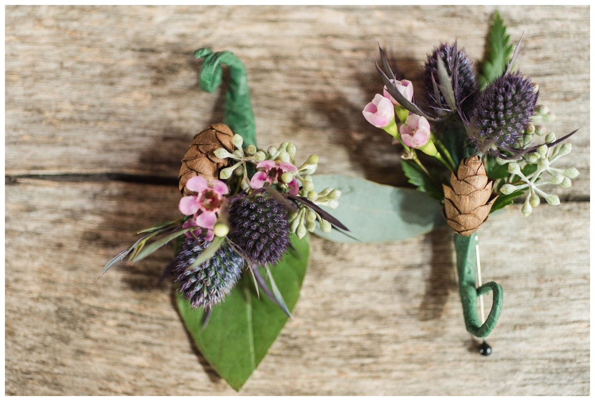 Whimsical Woodland Fall Wedding at mountain memories at thorpewood in thurmont maryland in october by sarah & dave photography richmond wedding photographer forest woodland whimsical fairy inspired boutonniere for groom and groomsmen inspiration pink flowers with deep purple thistle leaves and pinecone pinecones 