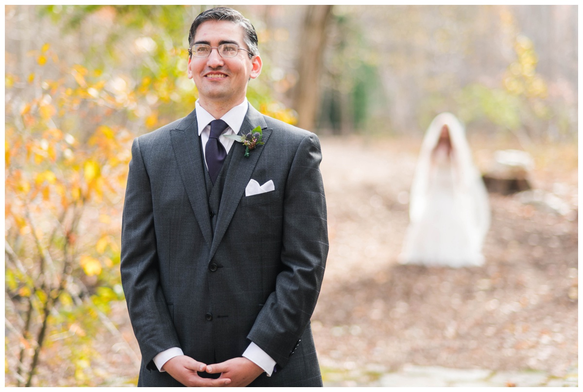 Whimsical Woodland Fall Wedding at mountain memories at thorpewood in thurmont maryland in october by sarah & dave photography richmond wedding photographer groom and bride first look photo inspiration purple tie charcoal gray black suit white wedding dress changing leaves focus on groom