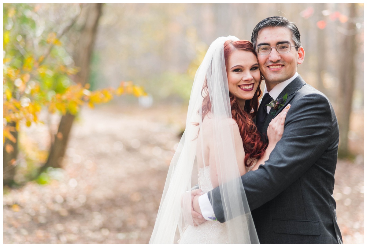Whimsical Woodland Fall Wedding at mountain memories at thorpewood in thurmont maryland in october by sarah & dave photography richmond wedding photographer groom and bride first look photo inspiration purple tie charcoal gray black suit white wedding dress changing leaves bride and groom close and smiling
