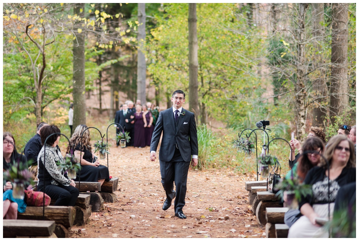 Whimsical Woodland Fall Wedding at mountain memories at thorpewood in thurmont maryland in october by sarah & dave photography richmond wedding photographer forest inspired outdoor ceremony in the woods groom walking down aisle log tree stump seating seats