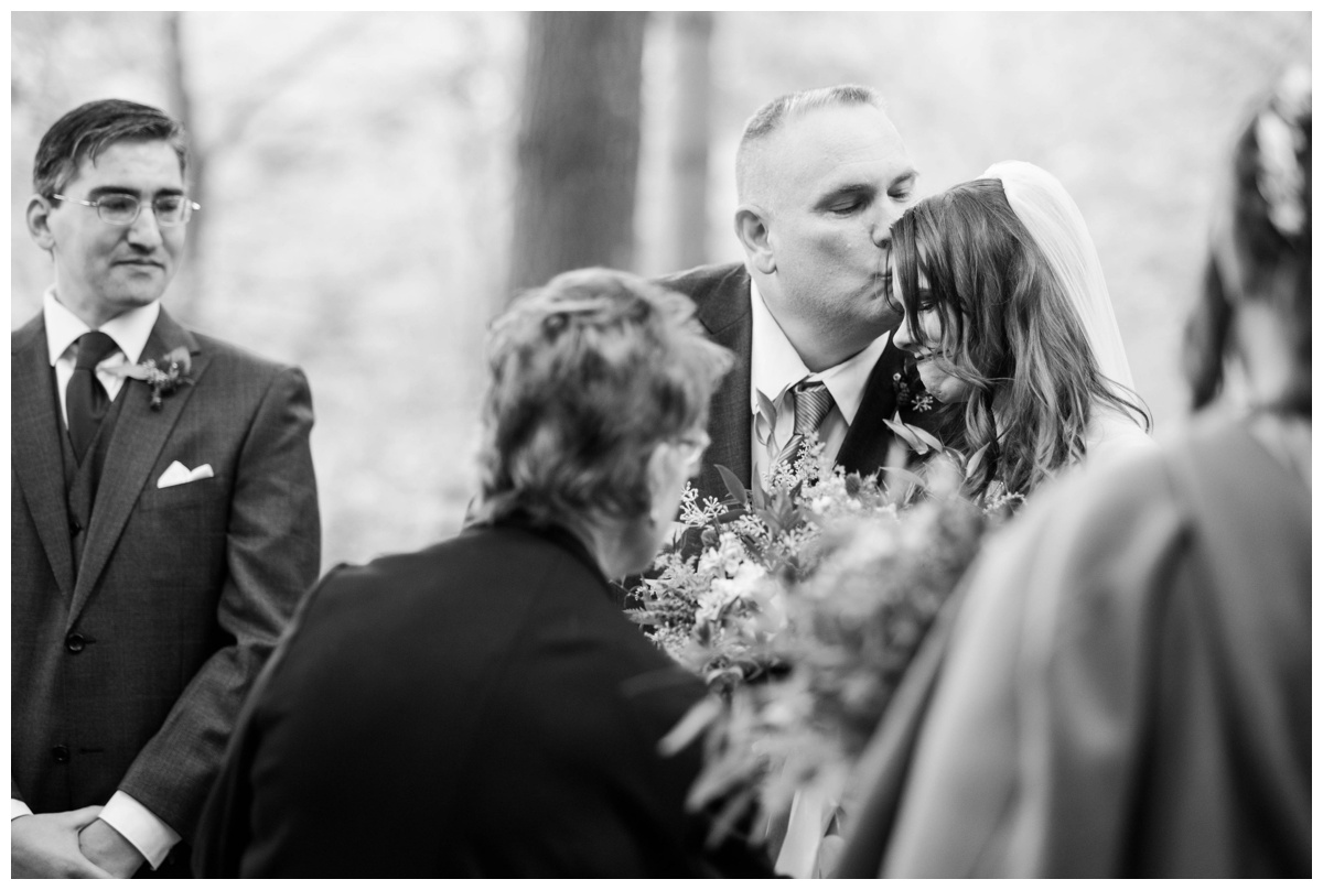 Whimsical Woodland Fall Wedding at mountain memories at thorpewood in thurmont maryland in october by sarah & dave photography richmond wedding photographer forest inspired outdoor ceremony in the woods father of the bride kissing bride at the altar 
