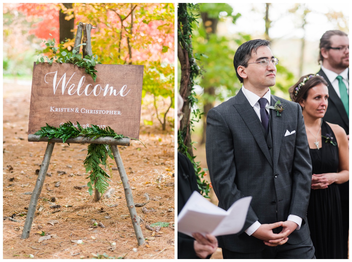 Whimsical Woodland Fall Wedding at mountain memories at thorpewood in thurmont maryland in october by sarah & dave photography richmond wedding photographer forest inspired outdoor ceremony in the woods wedding party and groom watching bride walking down the aisle log tree stump seating seats wooden woodland enchanted forest inspired welcome sign with log tree branch easel stand and greenery ferns garland