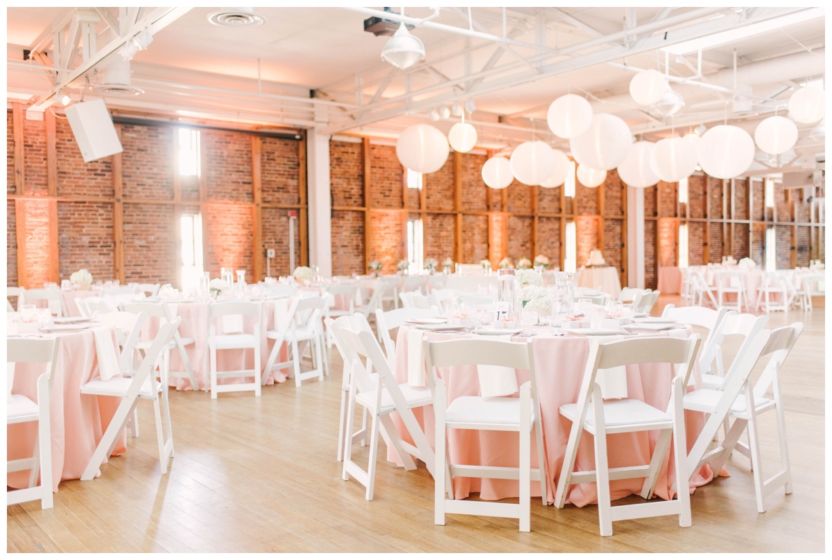 american visionary art museum wedding in baltimore maryland by richmond wedding photographer sarah & dave photography pink coral peach wedding colors summer pink coral peach and white wedding colors table setting design decoration inspiration paper ball spheres lanterns hanging from the ceiling