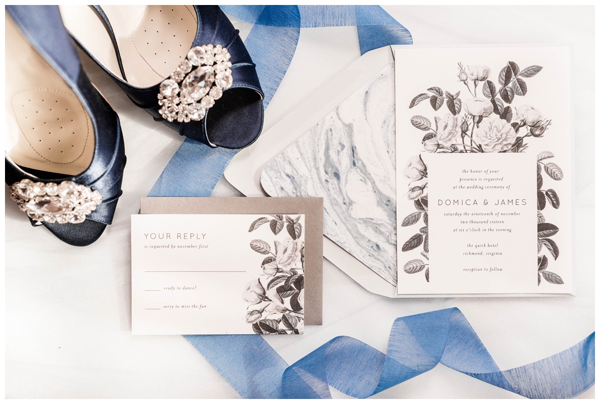 shades of blue wedding inspiration at quirk hotel in richmond virginia by rva wedding photographer sarah & dave photography bride and groom sitting on iconic quirk hotel couch rva virginia wedding blue wedding inspo ideas invitation suite trio grayscale black and white florals print marble accents paper
