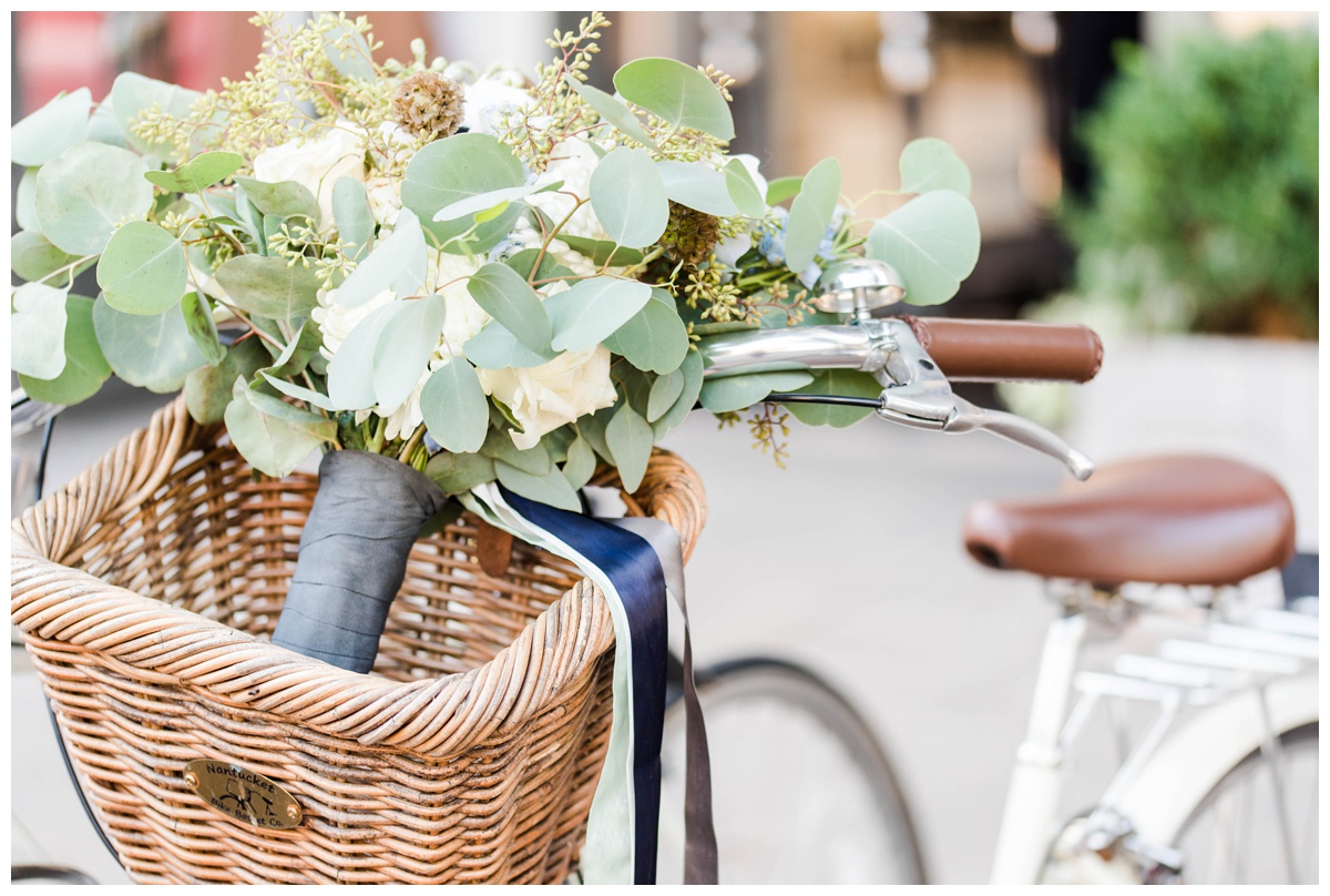 shades of blue wedding inspiration at quirk hotel in richmond virginia by rva wedding photographer sarah & dave photography quirk hotel richmond virginia outside inside wedding venue photo inspiration beach cruiser blue bicycle with basket and bridal bouquet flowers 