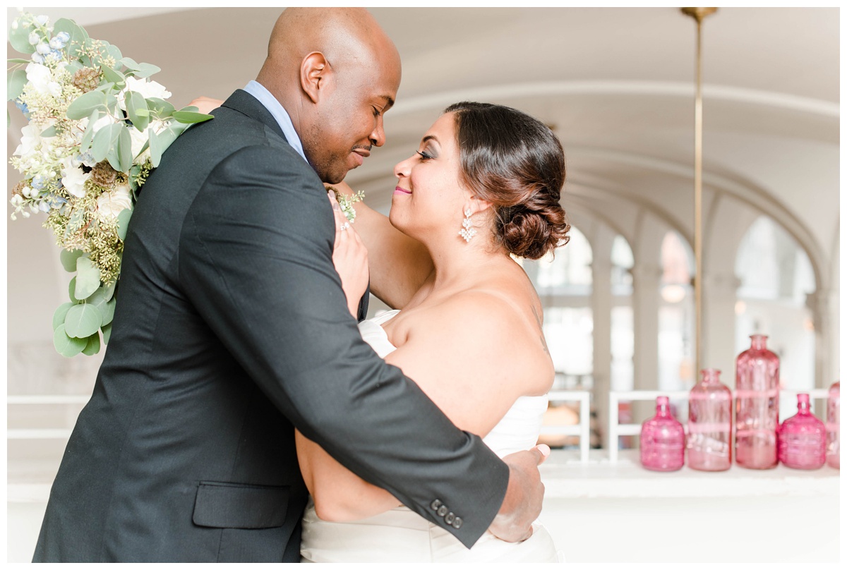 shades of blue wedding inspiration at quirk hotel in richmond virginia by rva wedding photographer sarah & dave photography bride and groom sitting on iconic quirk hotel couch rva virginia wedding blue wedding inspo ideas couple dancing bride and groom first dance