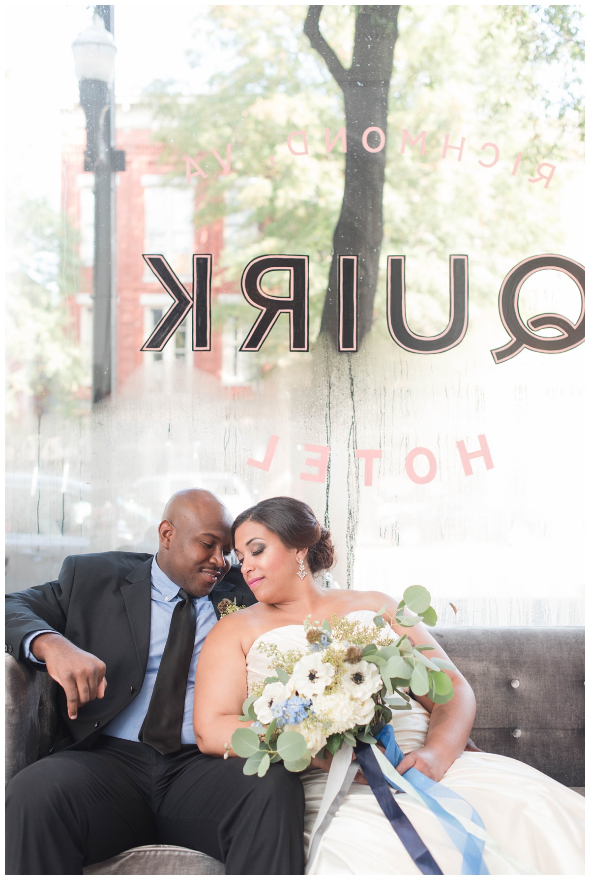 shades of blue wedding inspiration at quirk hotel in richmond virginia by rva wedding photographer sarah & dave photography bride and groom sitting on iconic quirk hotel couch rva virginia wedding blue wedding inspo ideas