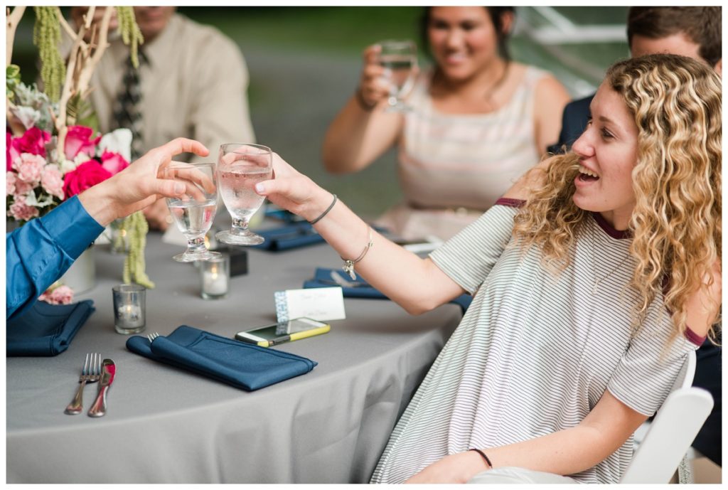 may wedding at oatlands historic house and gardens in the spring pink blue and silver wedding colors bride and groom smiling at each other by sarah and dave photography richmond wedding photographer toast speech glasses raised