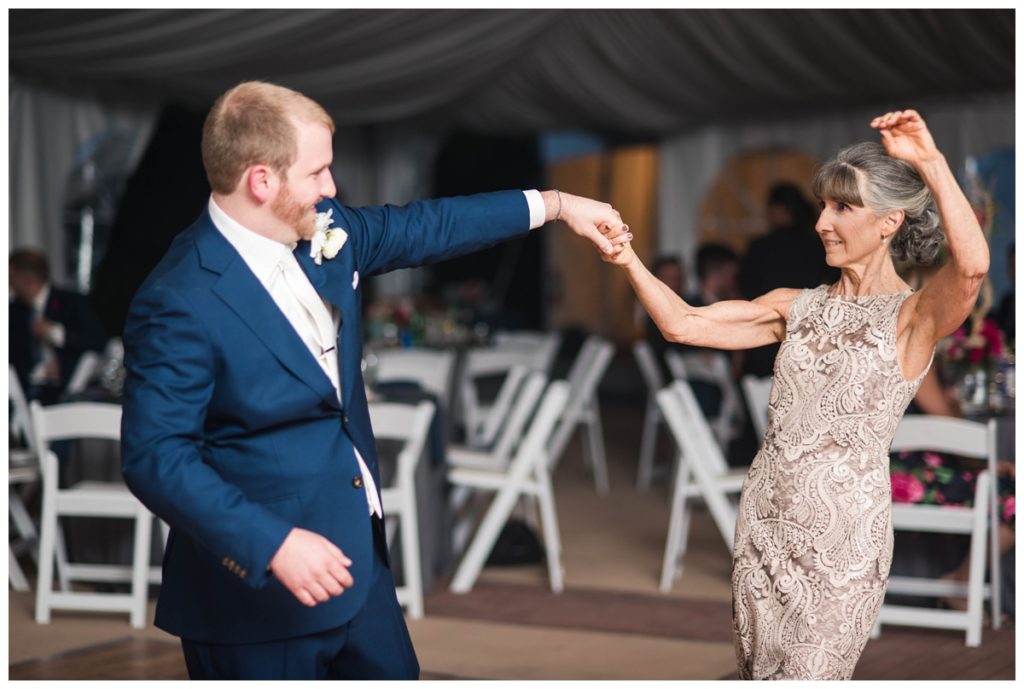 may wedding at oatlands historic house and gardens in the spring pink blue and silver wedding colors bride and groom smiling at each other by sarah and dave photography richmond wedding photographer toast speech and groom and mother of the groom first dance photo