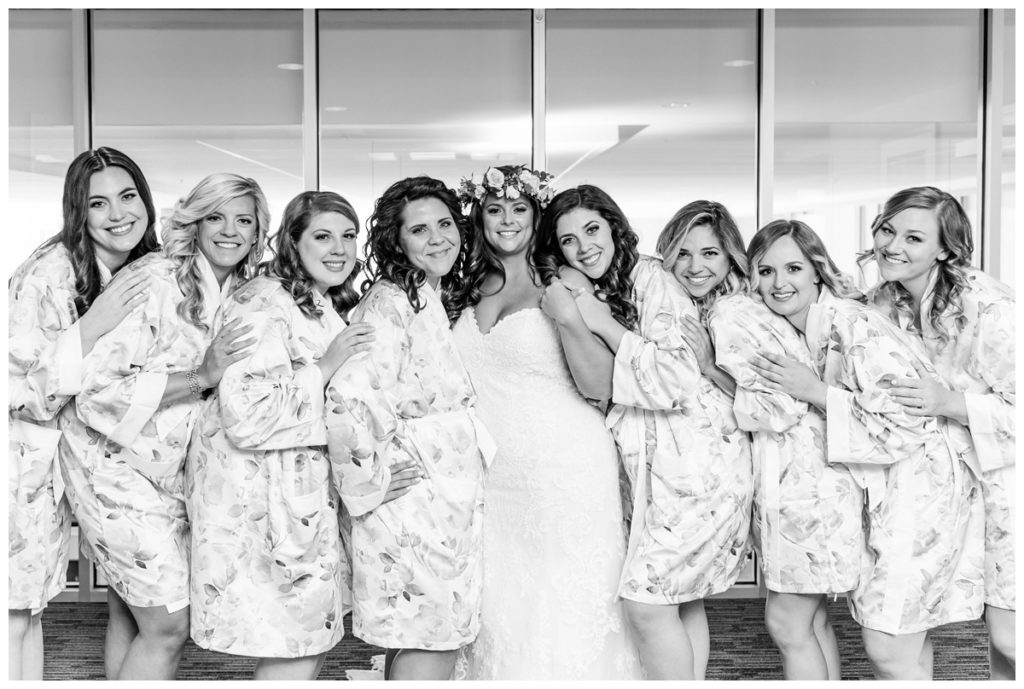 photo of wedding party in bridal robes and bride with flower crown in delaware hotel