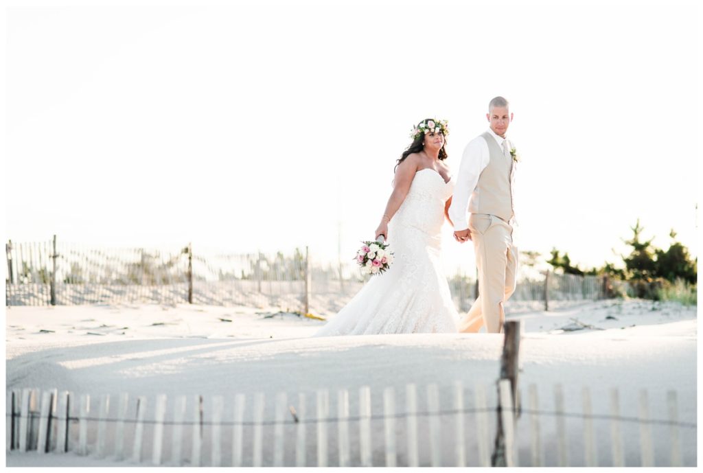 black and white beach wedding photo of bride and groom in front of sand dunes