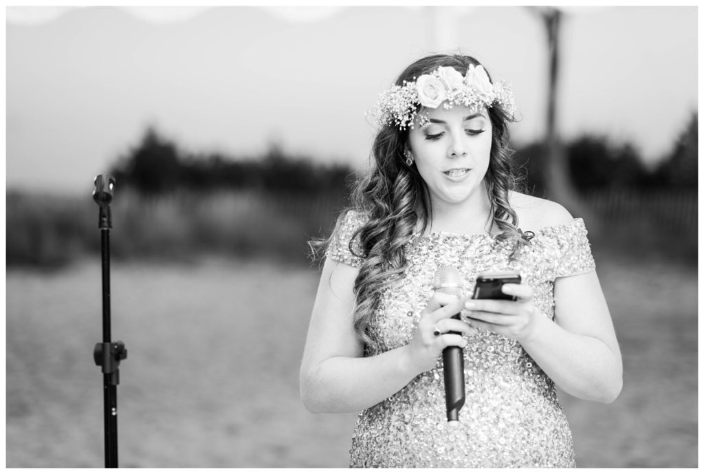 bridesmaid making speech wearing flower crown and holding phone