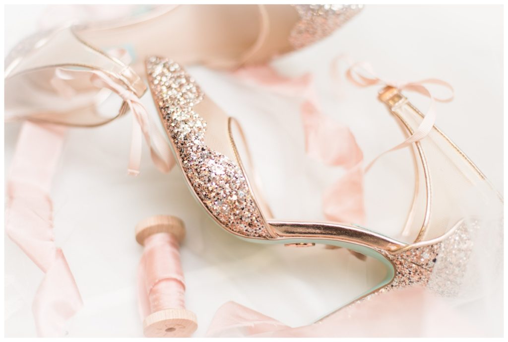 betsey johnson bridal shoes with pink glitter and ribbons flatlay pre wedding detail photo