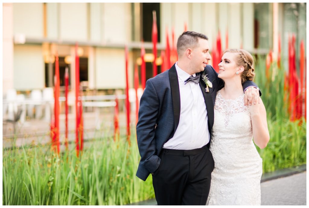 june wedding at vmfa in richmond with bride and groom outdoors in front of red flame sculpture