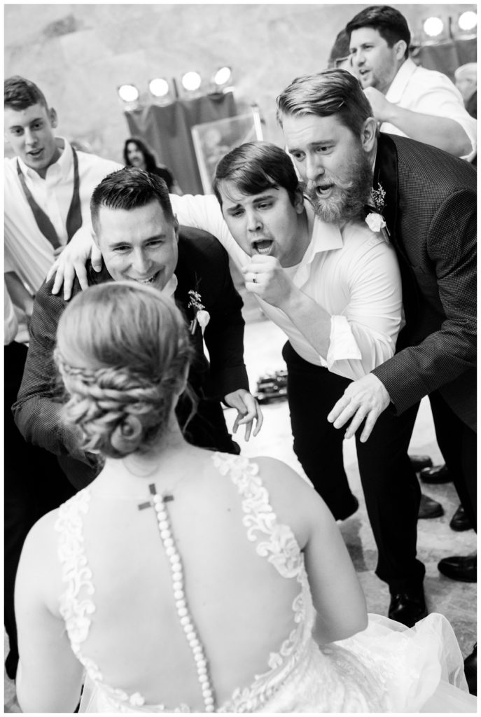 elegant summer wedding at the virginia museum of fine arts by richmond wedding photographer, sarah & dave photography. photo of groomsmen and groom serenading bride at wedding reception in the marble hall
