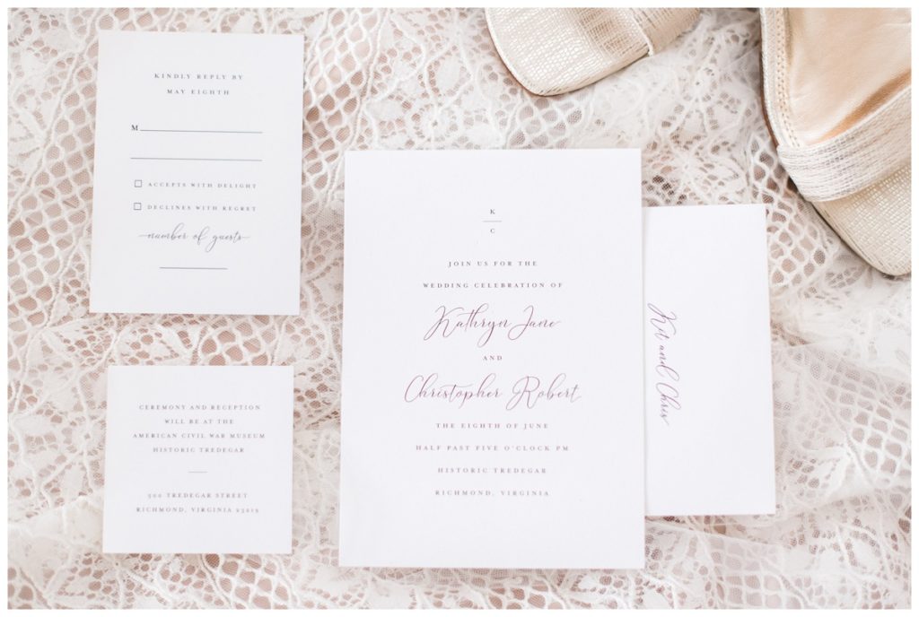 wedding invitation suite flatlay with carly reed designs invites and lillian west wedding dress flatlay