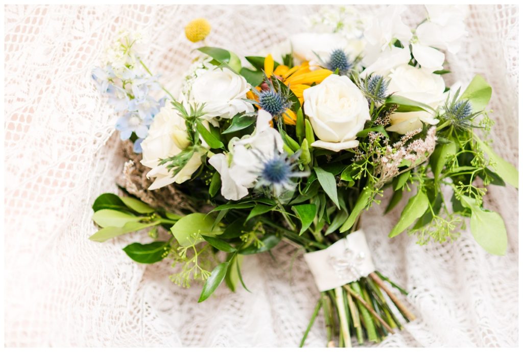 elegant, untamed bridal bouquet of greenery, black eyed susans, creamy white, and pastel light blue by amanda burnette floral design - richmond florist
