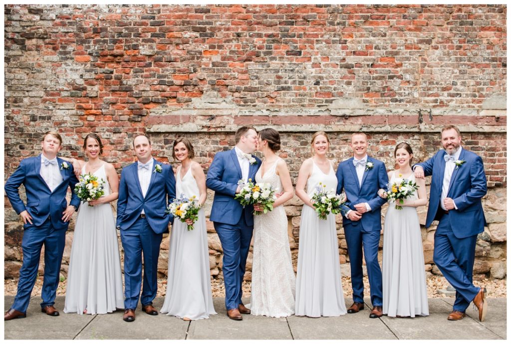outdoor wedding party photos with indigo blue menguin tuxedos and light grey and white revelry bridesmaid dresses attire at american civil war museum wedding at historic tredegar ironworks in richmond rva virginia by wedding photographer, sarah & dave photography