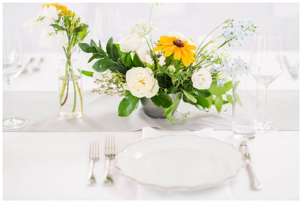 photo of chic floral arrangements and table decor and place settings at outdoor wedding reception at the american civil war museum and historic tredegar ironworks in richmond rva virginia by wedding photographer sarah & dave photography - amanda burnette floral design was the florist