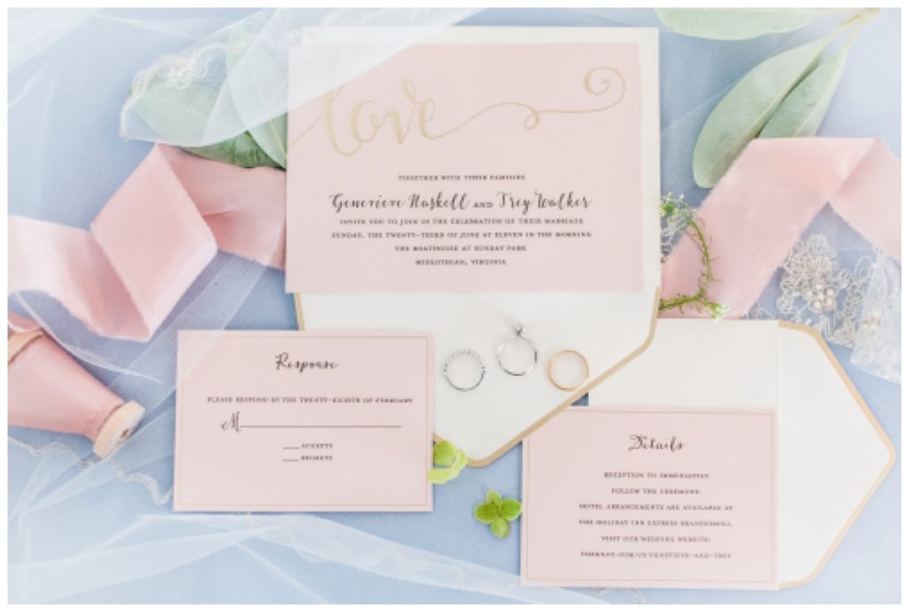 pink and blue cinderella disney princess inspired wedding invites - invitation flatlay for richmond wedding in the summer at the boathouse at sunday park - gold lettering with scrolling and pink ribbon