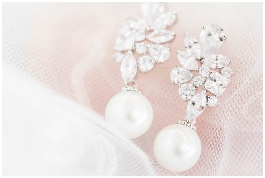 swoon worthy pearl and diamonds jewelry - earrings - bridal detail photo with veil