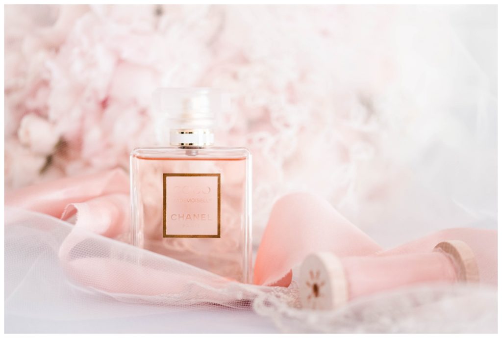 chanel perfume with light pink florals and bridal veil accent with light pink satin ribbon by richmond wedding photographer, sarah & dave photography - photo of bridal details