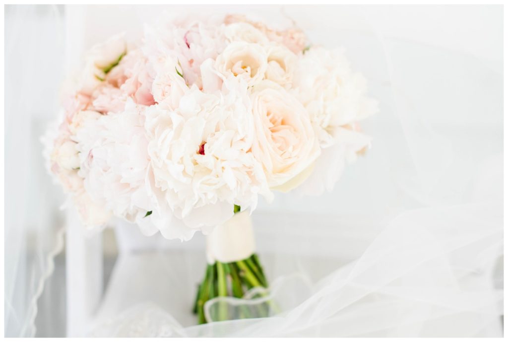 wedding flowers - light pink and green against veil