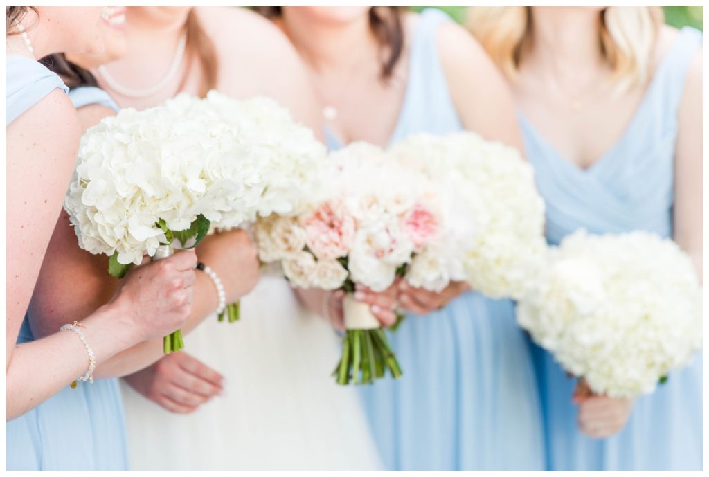 light blue bridesmaid dresses, white bouquets and bride wearing white wedding dress with light pink florals