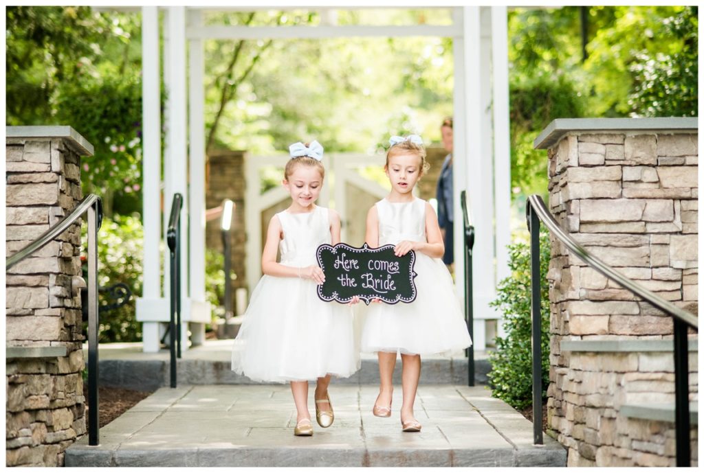 flower girls carrying here comes the bride sign at the boathouse at sunday park - richmond wedding venue - outdoors - summer wedding in june - richmond rva - fairytale inspired wedding