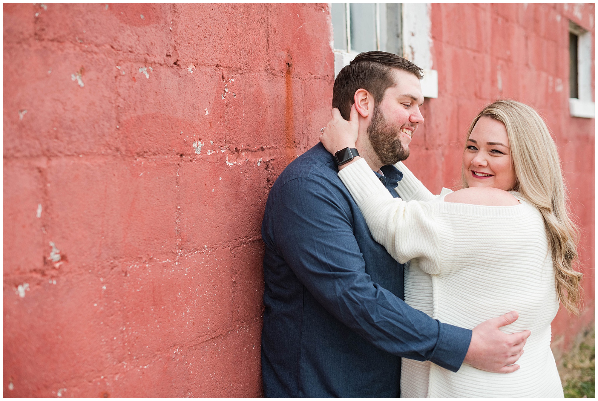 engagement photos in manquin virginia. in the fall. in november. by rva wedding photographer, sarah & dave photography. getting cozy along this cool brick red wall.